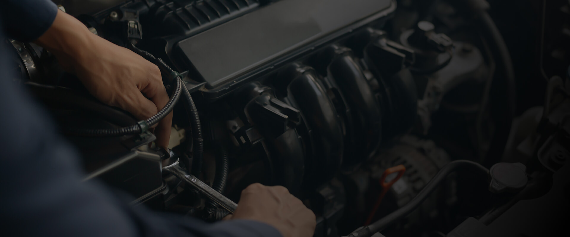 Mechanic performing logbook service on a vehicle engine